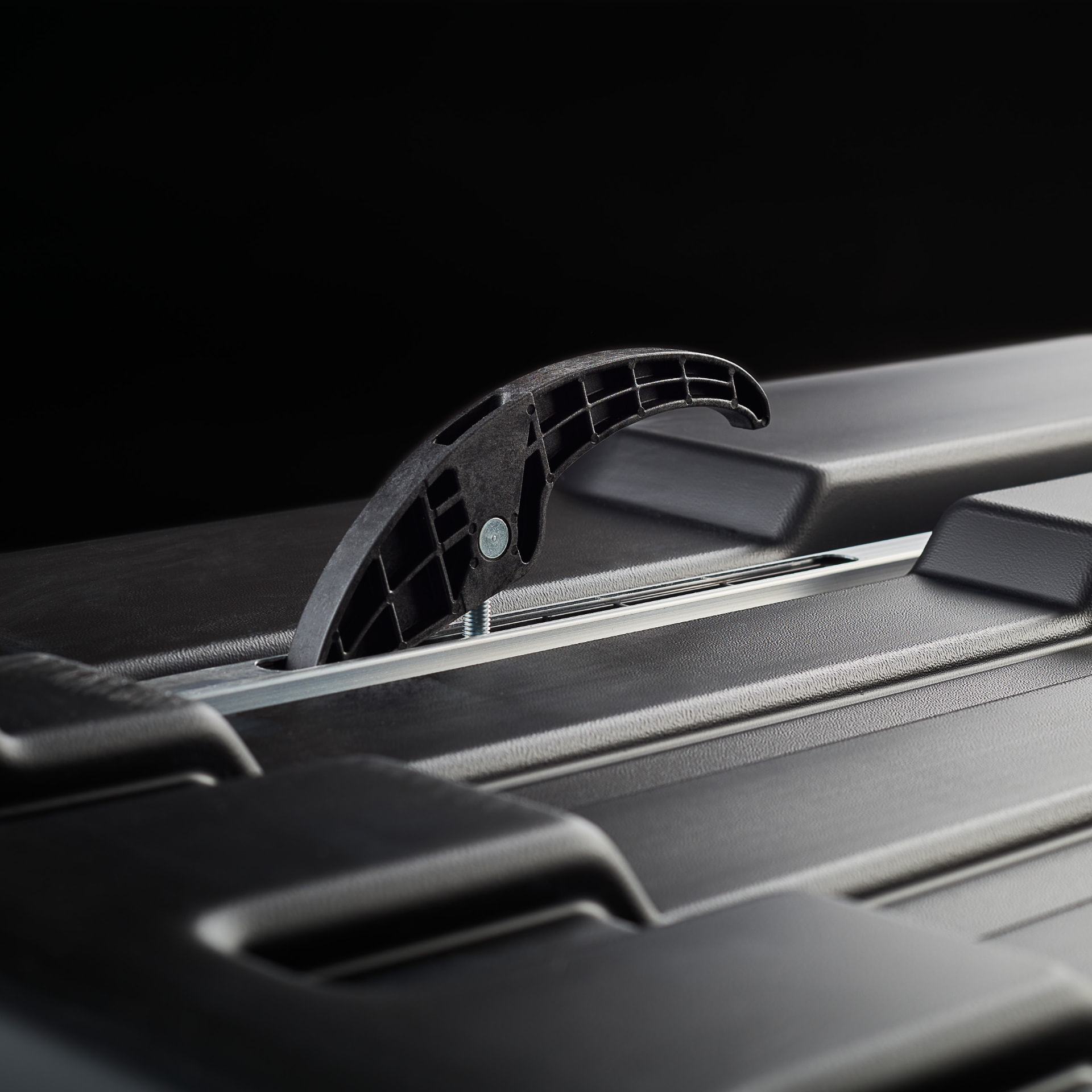 Upside down view of bottom of Roof box showing clamp to crossbar fixation